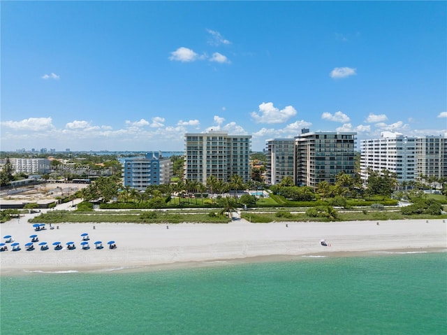 birds eye view of property with a water view, a city view, and a view of the beach
