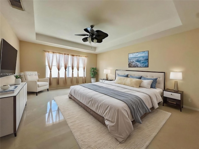 bedroom featuring visible vents, a ceiling fan, a raised ceiling, and baseboards