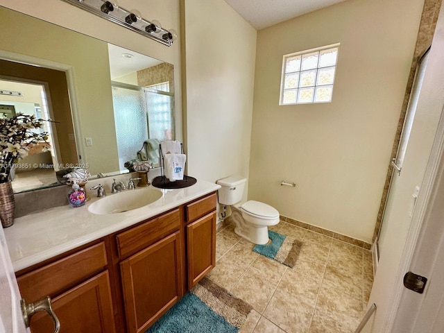full bath featuring vanity, toilet, baseboards, tile patterned floors, and a shower stall