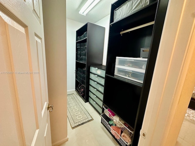 walk in closet featuring tile patterned flooring