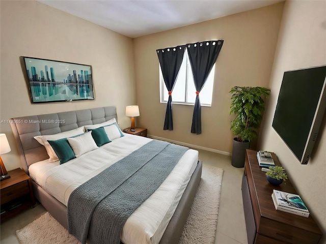 bedroom featuring baseboards and carpet
