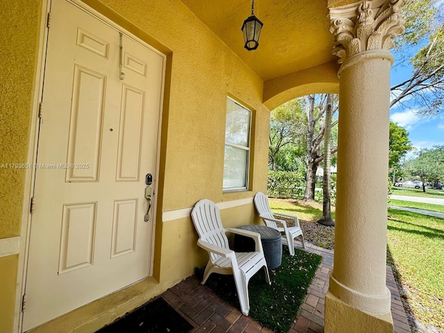 view of exterior entry featuring stucco siding