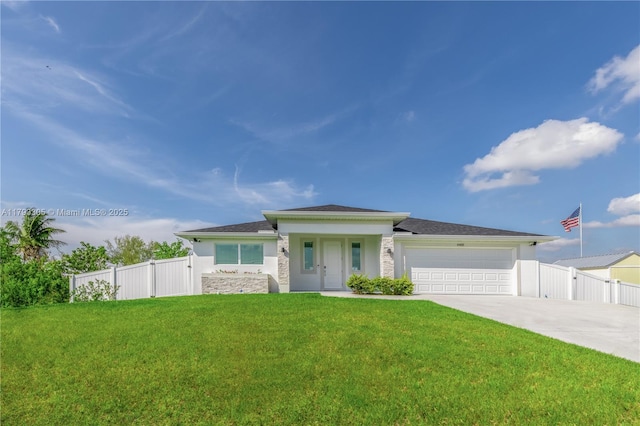 prairie-style home featuring fence, an attached garage, stucco siding, a front yard, and driveway