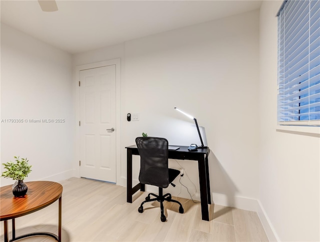 office area with baseboards and light wood finished floors