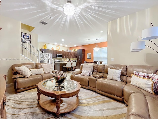 living room with recessed lighting, stairs, and visible vents