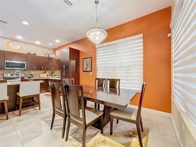 dining space with visible vents, light tile patterned floors, and a chandelier