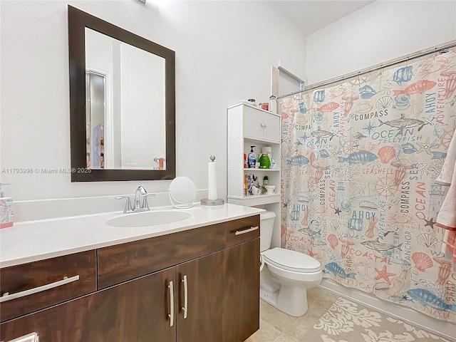 bathroom with vanity, tile patterned flooring, and toilet