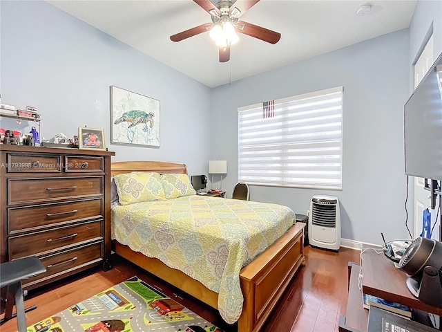bedroom featuring baseboards, ceiling fan, and dark wood-type flooring