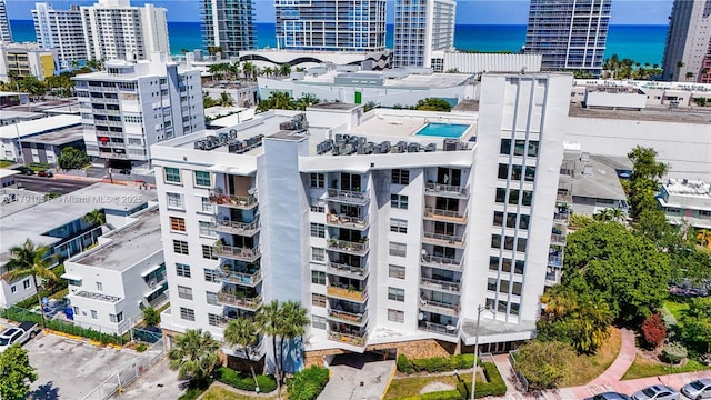 birds eye view of property featuring a view of city and a water view