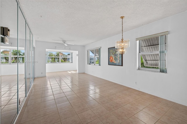 401 S Golf Blvd Unit 270, Pompano Beach, FL 33064 - tiled empty room with a chandelier, a textured ceiling, and ceiling fan