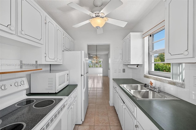 401 S Golf Blvd Unit 270, Pompano Beach, FL 33064 - kitchen featuring white appliances, light tile patterned floors, white cabinets, dark countertops, and a ceiling fan