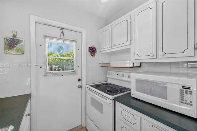 401 S Golf Blvd Unit 270, Pompano Beach, FL 33064 - kitchen with white appliances, decorative backsplash, white cabinets, and dark countertops