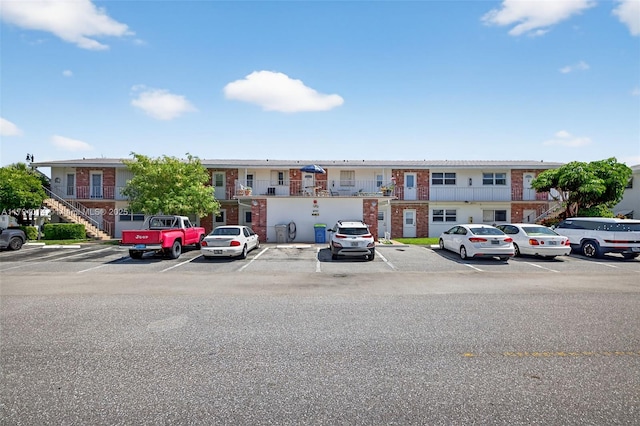 401 S Golf Blvd Unit 270, Pompano Beach, FL 33064 - view of front of property featuring uncovered parking, brick siding, and stairs