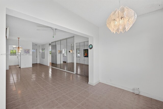 401 S Golf Blvd Unit 270, Pompano Beach, FL 33064 - unfurnished room with tile patterned flooring, a ceiling fan, and a chandelier