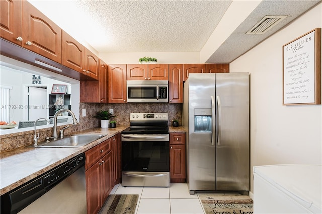 1100 N Hiatus Rd Unit 1100, Pembroke Pines, FL 33026 - kitchen featuring visible vents, light tile patterned flooring, a textured ceiling, a sink, and appliances with stainless steel finishes
