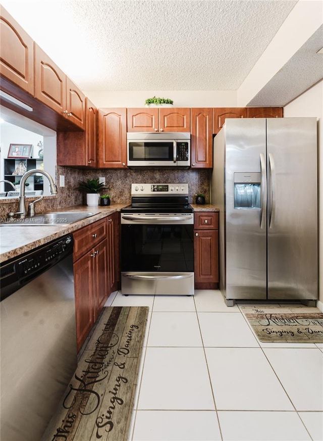 1100 N Hiatus Rd Unit 1100, Pembroke Pines, FL 33026 - kitchen with stainless steel appliances, a textured ceiling, decorative backsplash, and a sink