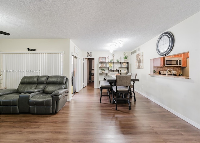 1100 N Hiatus Rd Unit 1100, Pembroke Pines, FL 33026 - dining room featuring visible vents, a textured ceiling, and wood finished floors
