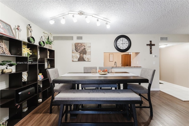 1100 N Hiatus Rd Unit 1100, Pembroke Pines, FL 33026 - dining room featuring a textured ceiling, wood finished floors, and visible vents