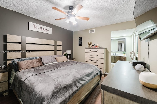 1100 N Hiatus Rd Unit 1100, Pembroke Pines, FL 33026 - bedroom featuring ensuite bathroom, dark wood finished floors, a textured ceiling, and visible vents