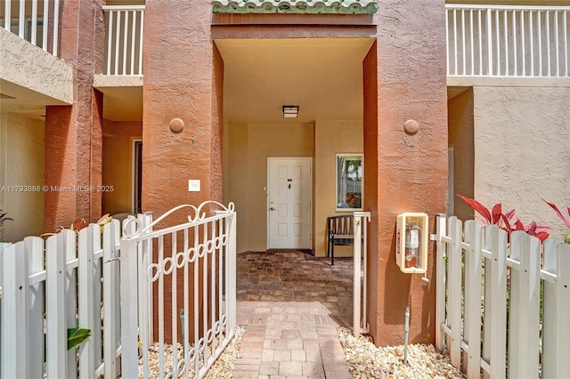 7715 Southampton Ter Unit 110, Tamarac, FL 33321 - view of exterior entry featuring fence and stucco siding