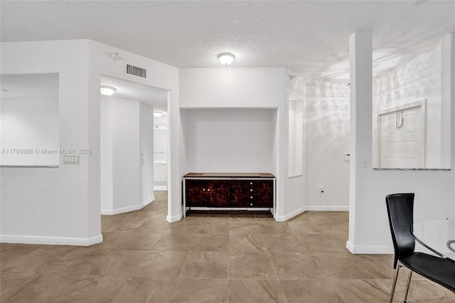 7715 Southampton Ter Unit 110, Tamarac, FL 33321 - interior space featuring visible vents, a textured ceiling, and baseboards