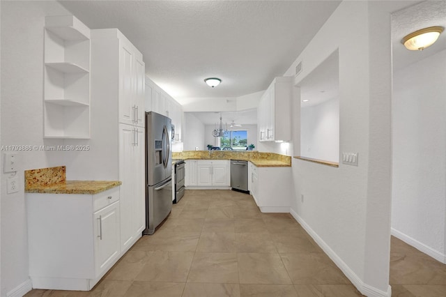 7715 Southampton Ter Unit 110, Tamarac, FL 33321 - kitchen featuring an inviting chandelier, appliances with stainless steel finishes, open shelves, and white cabinetry