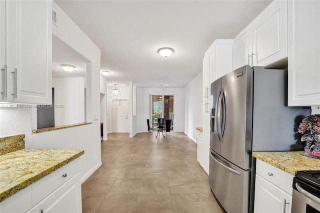7715 Southampton Ter Unit 110, Tamarac, FL 33321 - kitchen with visible vents, light stone countertops, baseboards, white cabinets, and stainless steel fridge with ice dispenser