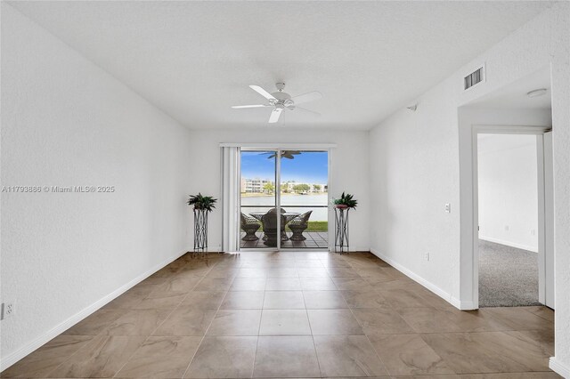 7715 Southampton Ter Unit 110, Tamarac, FL 33321 - empty room with ceiling fan, visible vents, baseboards, and tile patterned flooring