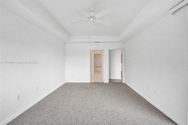 7715 Southampton Ter Unit 110, Tamarac, FL 33321 - unfurnished bedroom with carpet floors, a ceiling fan, a raised ceiling, and baseboards