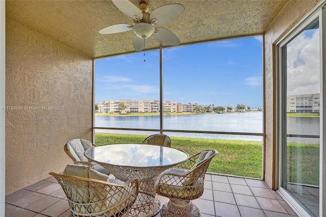 7715 Southampton Ter Unit 110, Tamarac, FL 33321 - sunroom featuring a water view, tile patterned flooring, a ceiling fan, and a textured wall