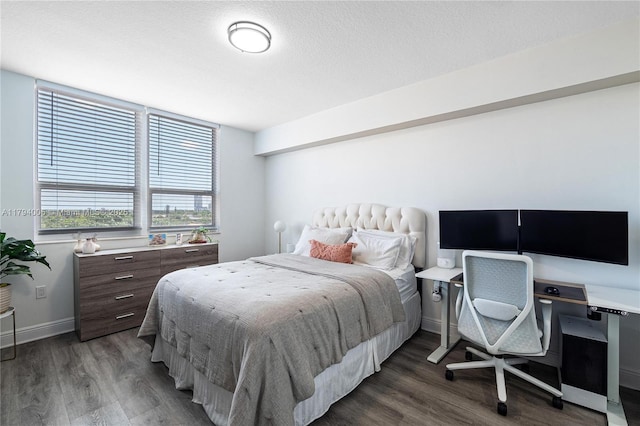 bedroom featuring baseboards and wood finished floors