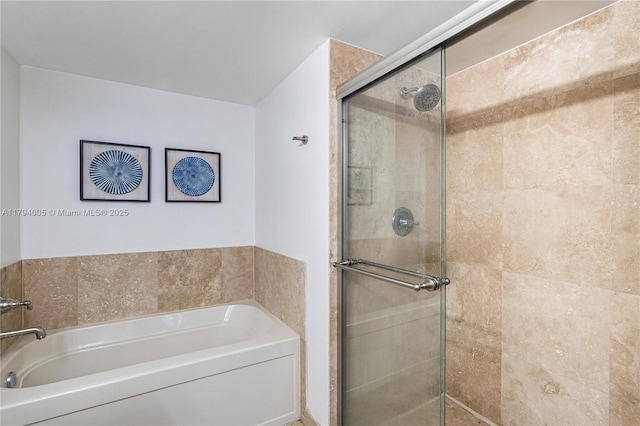 full bathroom featuring a garden tub and a stall shower