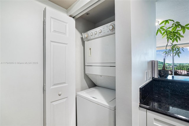 washroom with laundry area and stacked washer and clothes dryer
