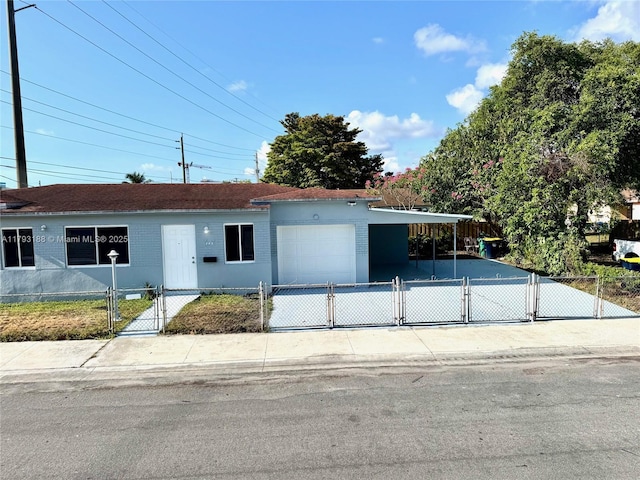 145 NW 2nd St, Dania Beach, FL 33004 - ranch-style house with a garage, a fenced front yard, a gate, and concrete driveway