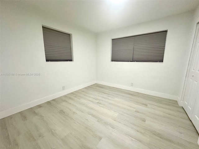 145 NW 2nd St, Dania Beach, FL 33004 - empty room with wood finished floors and baseboards