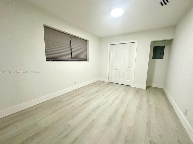 145 NW 2nd St, Dania Beach, FL 33004 - unfurnished bedroom featuring light wood finished floors, a closet, baseboards, and electric panel