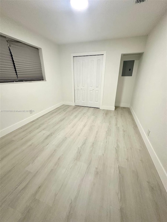 145 NW 2nd St, Dania Beach, FL 33004 - unfurnished bedroom featuring wood finished floors, baseboards, and a closet