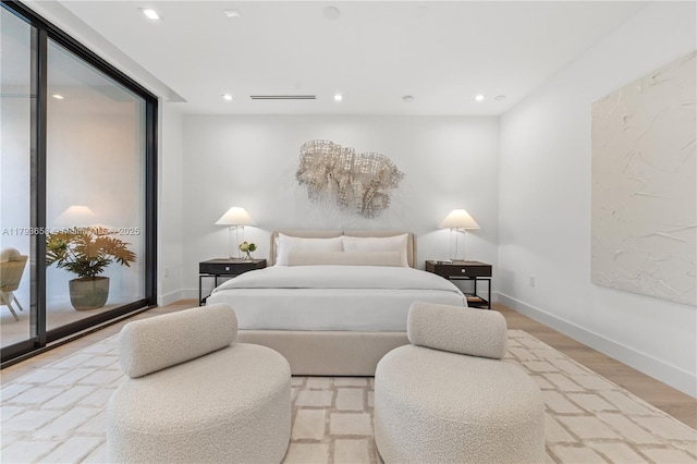 bedroom with baseboards, recessed lighting, wood finished floors, and access to exterior
