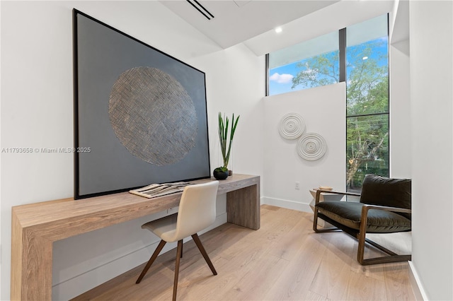 office area featuring light wood-style floors and baseboards