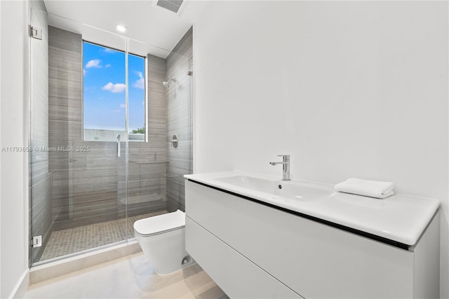 bathroom with vanity, a shower stall, toilet, and visible vents