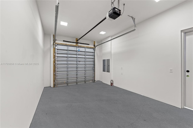 garage with a garage door opener and electric panel