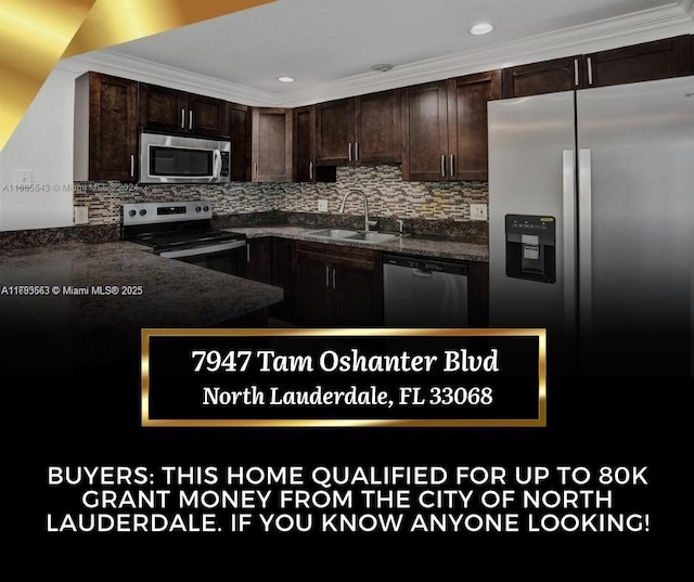 kitchen with appliances with stainless steel finishes, a sink, dark brown cabinetry, and tasteful backsplash