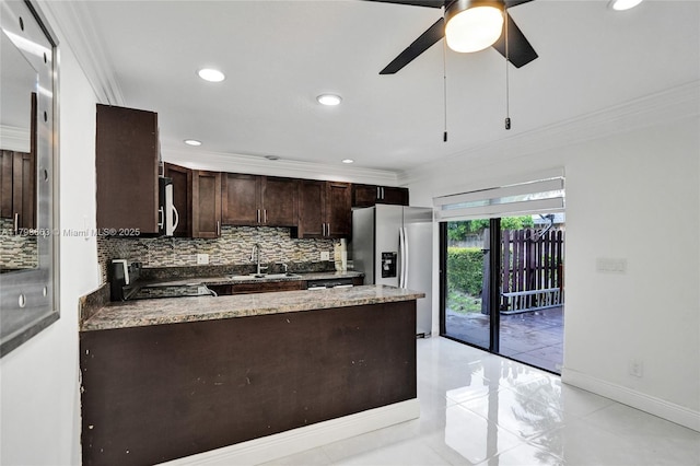 kitchen featuring range with electric stovetop, stainless steel refrigerator with ice dispenser, a sink, decorative backsplash, and crown molding