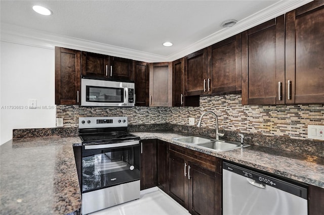 kitchen with appliances with stainless steel finishes, a sink, decorative backsplash, dark brown cabinets, and crown molding