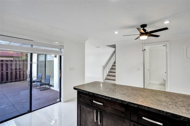 kitchen featuring crown molding, a ceiling fan, dark countertops, recessed lighting, and baseboards