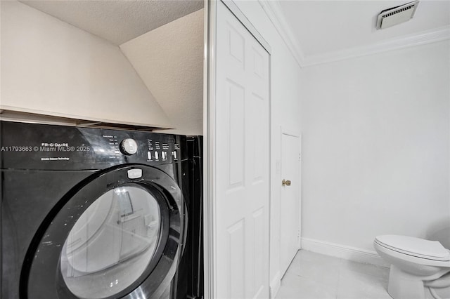 clothes washing area featuring washer / clothes dryer, ornamental molding, baseboards, a textured ceiling, and tile patterned flooring