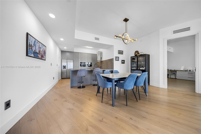 16001 Collins Ave Unit 707, Sunny Isles Beach, FL 33160 - dining room featuring light wood-style flooring, a chandelier, baseboards, and recessed lighting