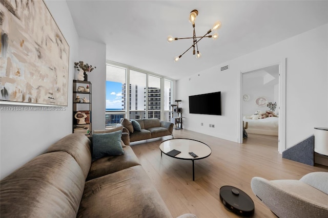 16001 Collins Ave Unit 707, Sunny Isles Beach, FL 33160 - living room with a chandelier, wood finished floors, and a wall of windows