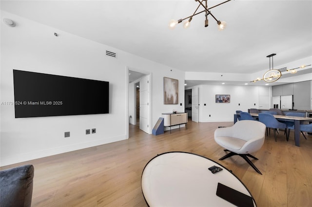 16001 Collins Ave Unit 707, Sunny Isles Beach, FL 33160 - living room featuring a chandelier, light wood-type flooring, and baseboards