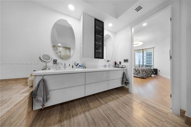 16001 Collins Ave Unit 707, Sunny Isles Beach, FL 33160 - bathroom featuring double vanity, connected bathroom, recessed lighting, and wood finished floors